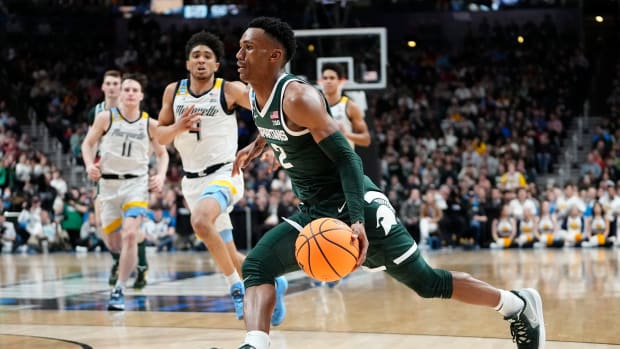 Michigan State Spartans guard Tyson Walker dribbles to the rim.